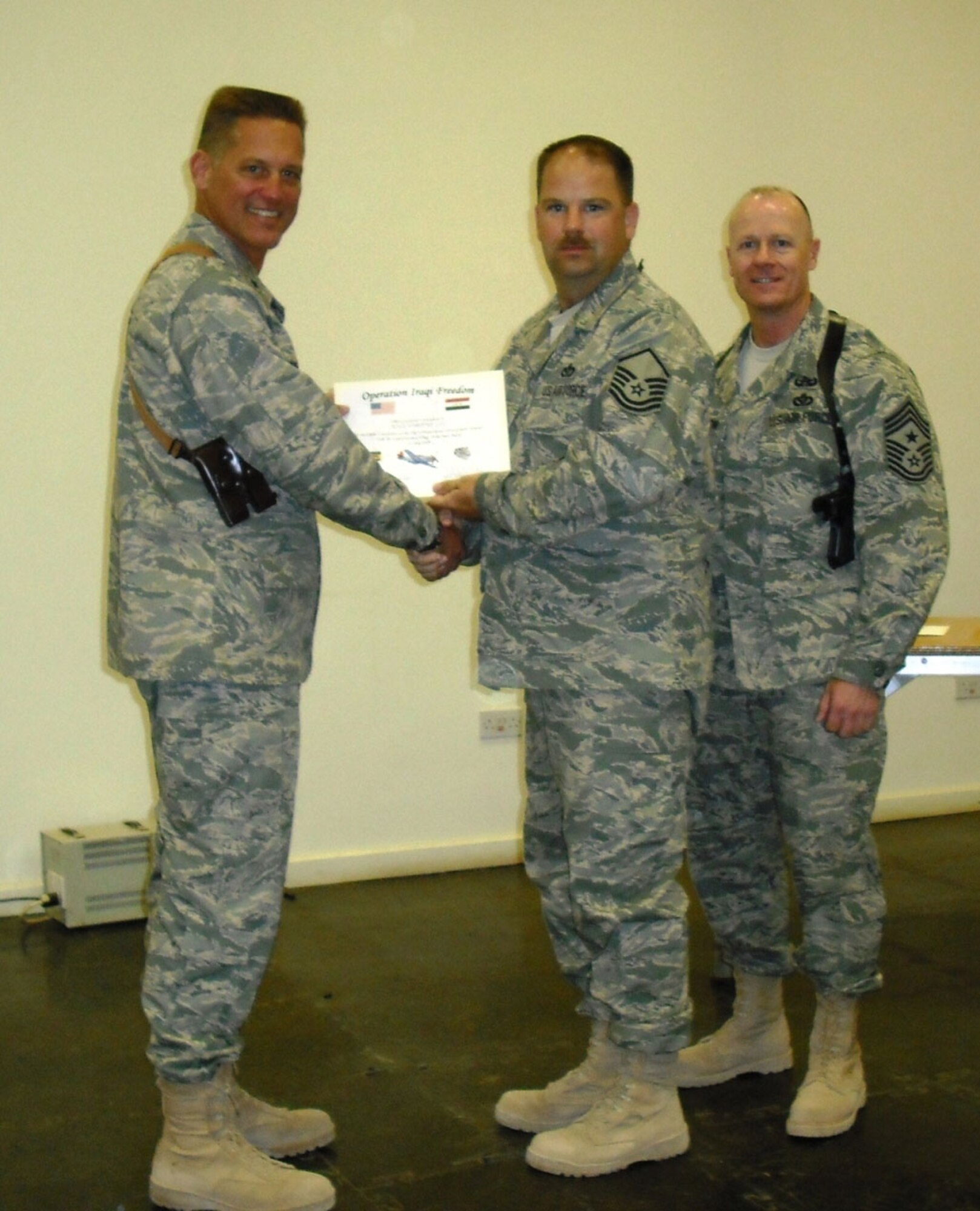 SEYMOUR JOHNSON AIR FORCE BASE, N.C. -- Master Sgt. Tim Lee is presented with his Senior Non-commissioned Officer Leadership Seminar certificate while stationed in Balad, Iraq. Sgt. Lee is a member of the 916th Civil Engineer Squadron and was presented the certificate by Brig. Gen. Brian Bishop. Another 916th Reservist, Senior Master Sgt. Bryan Payne, ran this leadership program that teaches writing, force structure, military family issues, mentoring, discipline, team building and financial management over the period of a day.