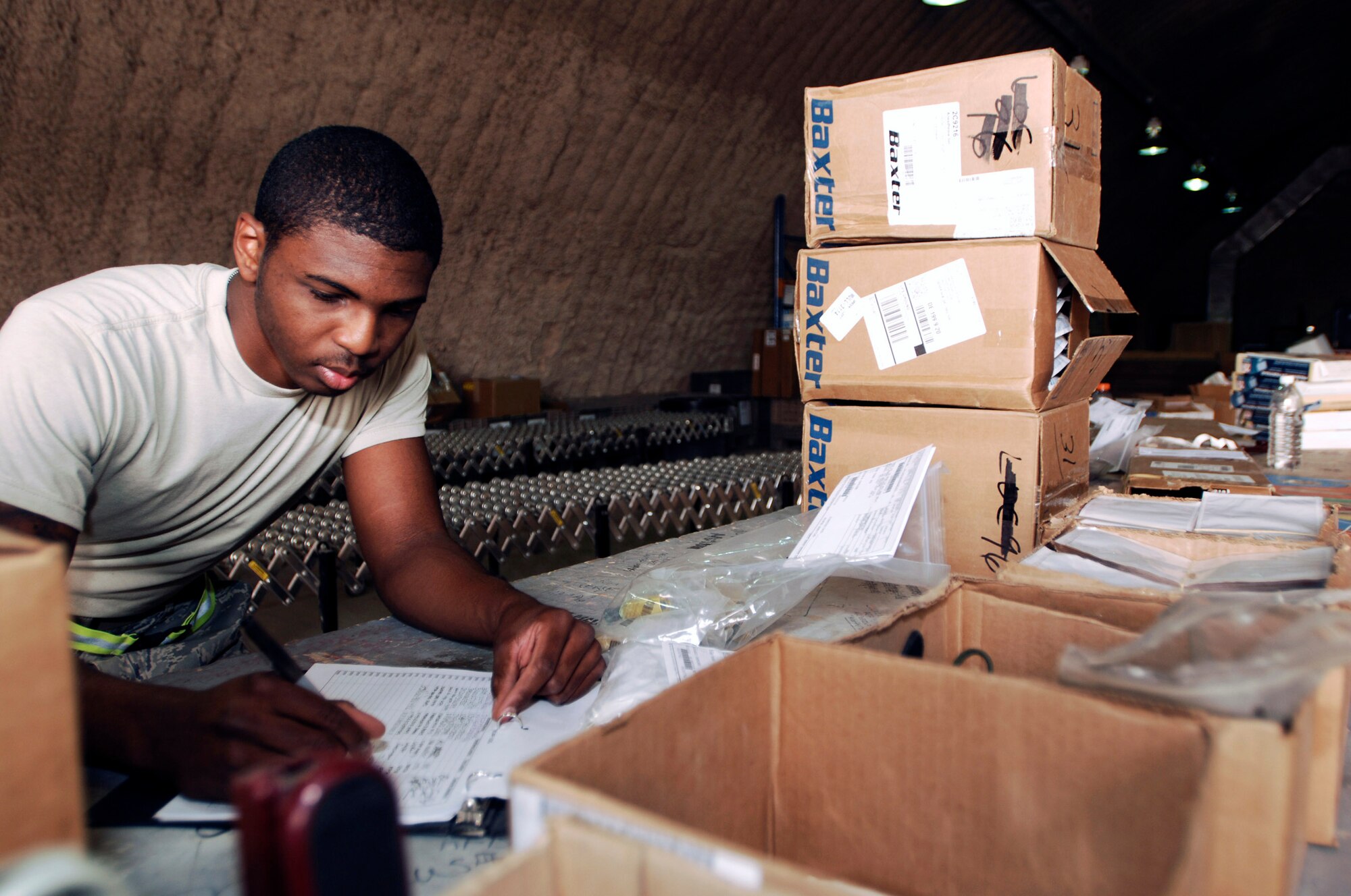 Airman 1st Class Curtis McCord checks in aircraft parts and supplies Aug. 5 at Joint Base Balad, Iraq. The 332nd Expeditionary Logistics Readiness Squadron's Receiving Flight Service Center Airmen process approximately 350 aircraft parts a week, including broken parts and replacements, which they ship to recipients across the base. Airman McCord, a flight service center journeyman assigned to the 332nd ELRS, is deployed from Davis-Monthan Air Force Base, Ariz. His hometown is Troy, Ala. (U.S. Air Force photo/Airman 1st Class Jason Epley) 
