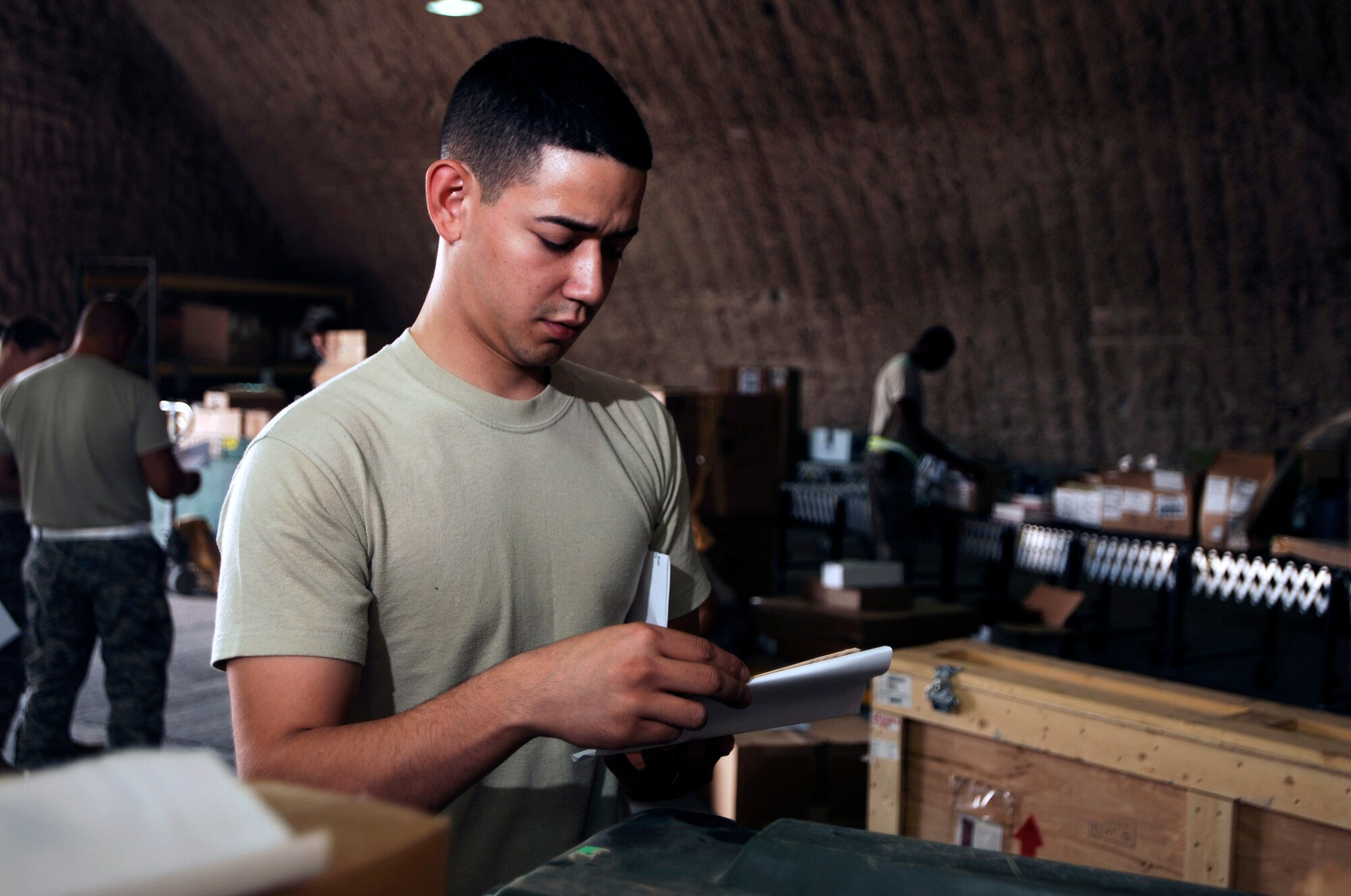 Airman 1st Class Carlos Fuentes validates documentation on parts due in for maintenance Aug. 5 at Joint Base Balad, Iraq. The 332nd Expeditionary Logistics Readiness Squadron's Receiving Flight Service Center Airmen process approximately 350 aircraft parts a week, including broken parts and replacements. Airman Fuentes, a flight service center journeyman assigned to the 332nd ELRS, is deployed from Davis-Monthan Air Force Base, Ariz. His hometown is Houston. (U.S. Air Force photo/Airman 1st Class Jason Epley) 
