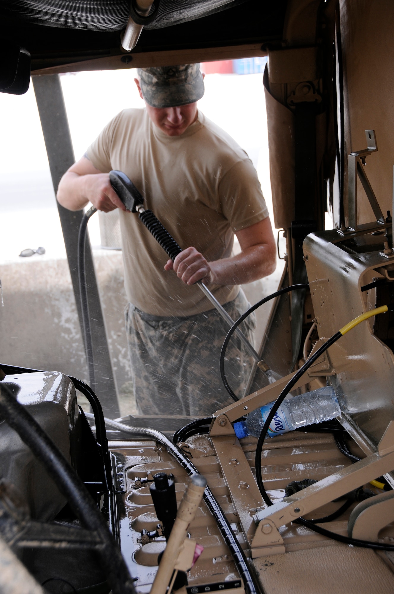 Private 1st Class Kevin Page, A 2-43, Air Defense Artillery from Fort Bliss, Texas, hoses out the passenger compartment of a Battery Command Post (BCP) vehicle Aug. 7, 2008.  The soldiers are cleaning the BCP in preparation for shipping it back to Texas from an undisclosed airbase in Southwest Asia.  (U.S. Air Force photo by Tech. Sgt. Michael Boquette/RELEASED)