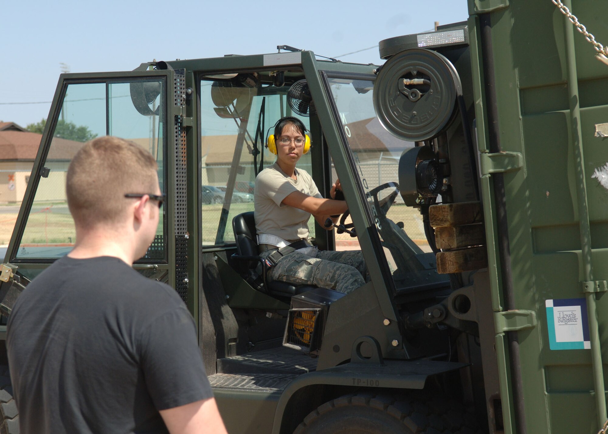 DYESS AIR FORCE BASE, TEXAS -- Staff Sgt. Michael Botti supervises Senior Airman Noel Brown while she operates a forklift to transport a cargo palette during the Cargo Rodeo, July 30. Airmen who participate in cargo rodeo's are subject to a 12 hour shift as well as weighing, measuring, packing, and loading cargo onto aircraft. (U.S. Air Force Photo by Airman 1st Class Micheal Breaux).