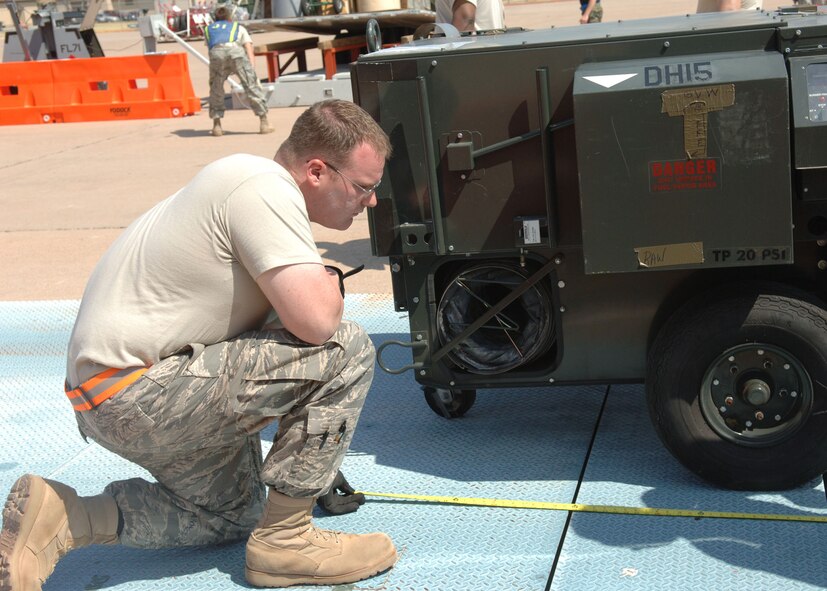 DYESS AIR FORCE BASE, TEXAS -- Staff Sgt. Bryan Bloom measures the length of an heater on a cargo palette during the Cargo Rodeo, July 30. During a Cargo Rodeo, Airmen must measure and weigh pieces of cargo that are due to be loaded on an aircraft to avoid weighing down the aircraft. (U.S. Air Force Photo by Airman 1st Class Micheal Breaux).