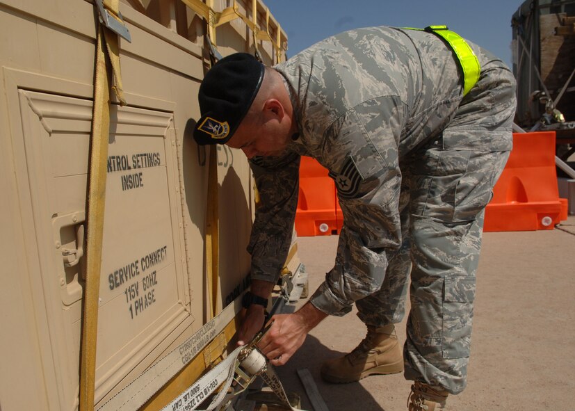 DYESS AIR FORCE BASE, TEXAS -- Technical Sergeant Richard Burke, 7 Security Forces Squadron, tightens down a strap on a peice of cargo during the Cargo Rodeo, July 30. Cargo Rodeos are conducted mainly for training of an upcoming Operational Readiness Inspection, but are also practice for real-time situations. (U.S. Air Force Photo by Airman 1st Class Micheal Breaux).