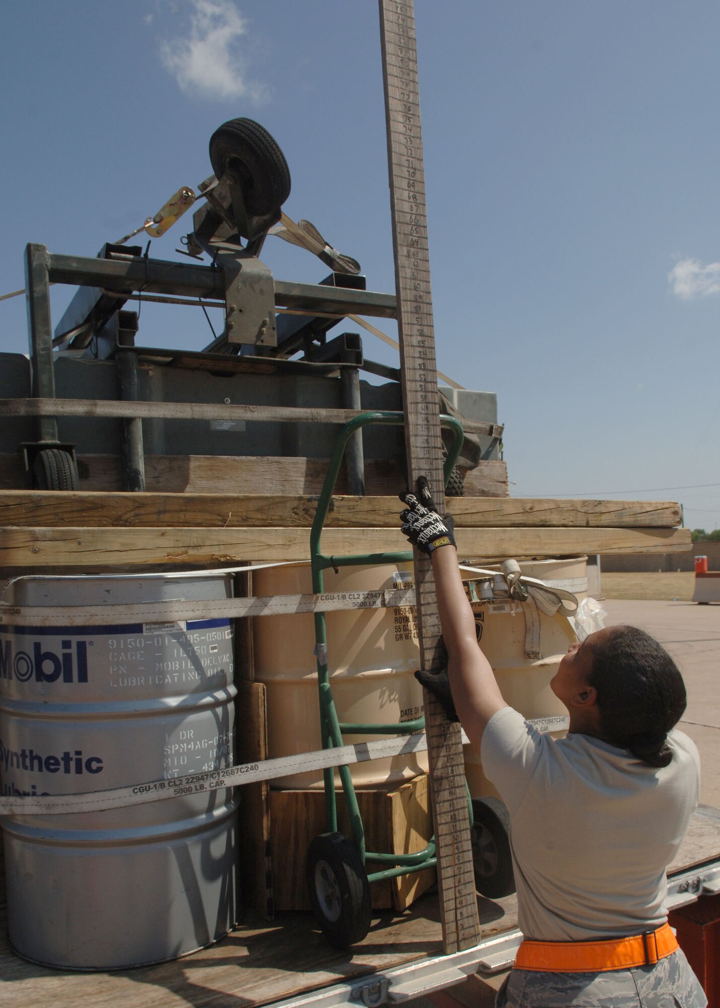 DYESS AIR FORCE BASE, TEXAS -- Airman 1st Rochel Russell, 7th Logistics Readiness Squadron, measures the height of a peice of cargo during the Cargo Rodeo, July 30. During a Cargo Rodeo, Airmen must  pack and inspect cargo as well as weigh and measure it for training of an Operational Readiness Inspection. (U.S. Air Force Photo by Airman 1st Class Micheal Breaux).
