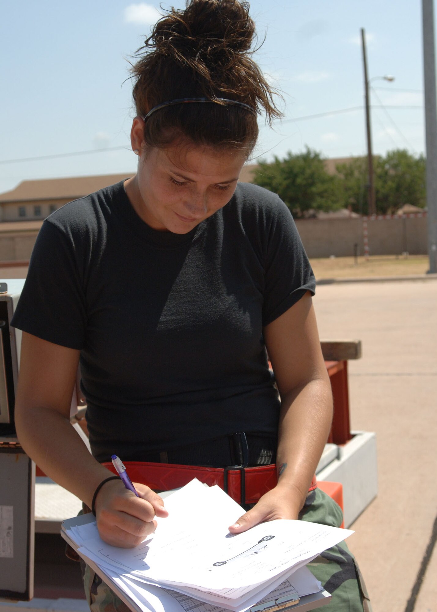 DYESS AIR FORCE BASE, TEXAS -- Airman 1st Class Chelsea Childs records the weight and height of cargo during the Cargo Rodeo, July 30. A Cargo Rodeo consists of simulating packing and inspecting cargo for preparation of an Operational Readiness Inspection. (U.S. Air Force Photo by Airman 1st Class Micheal Breaux).
