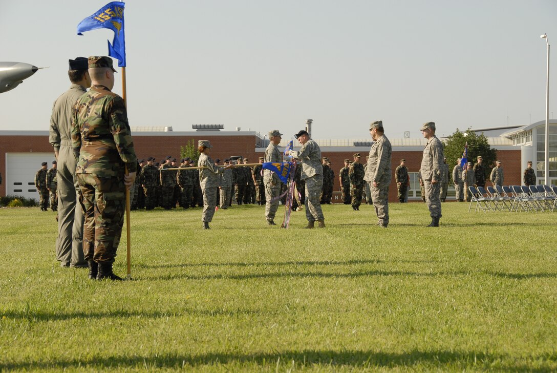Brig. Gen. Timothy K. Kadavy, Adjutant General Nebraska,(center right) pins the ninth Air Force Outstanding Unit Award streamer on the 155th Air Refueling Wing flag during a Honors Ceremony held at the Nebraska Air National Guard base on 3 August, 2008. The 155th ARW was cited for support of Homeland Defense, Operation Noble Eagle, Operation Iraqi Freedom, Environmental Protection, Compliance Inspections, Community Involvement, and Flying Safety.  (Nebraska Air National Guard photo by Senior Master Sgt. Lee Straube)(Released)
