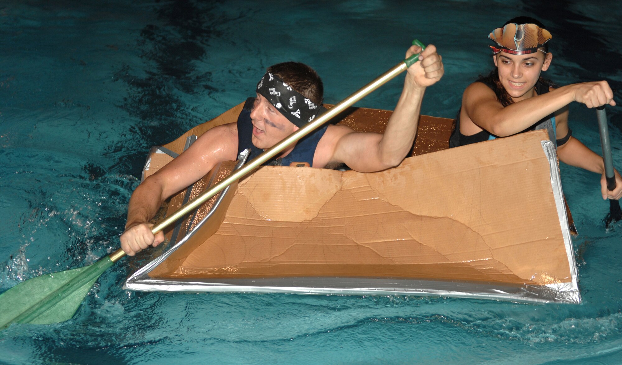 Airman 1st Class Joshua Keith and Airman 1st Class Tiffany Deas from the  4th Component Maintenance Squadron race their newly-constructed cardboard boat during the Build-a-Boat competition August 1, 2008, Seymour Johnson Air Force Base, North Carolina. The Build-a-Boat competition's purpose was to boost morale and help Airman meet other Airman. (U.S. Air Force photo by Airman 1st Class Gino Reyes)