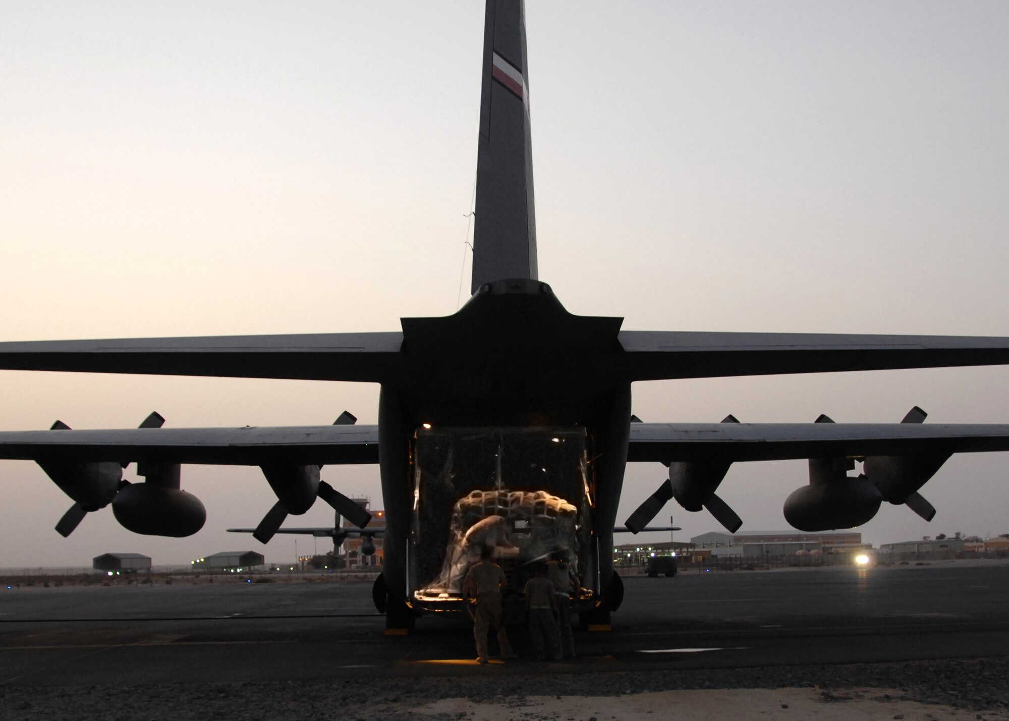 SOUTHWEST ASIA -- Cargo is being loaded on a C-130 assigned to the 386th Expeditionary Operations Group en route to Iraq on Aug. 6 at a base in Southwest Asia. The 386th Air Expeditionary Wing has moved close to half a million passengers and more than 57,000 tons of cargo this year alone, in support of Operations Iraqi Freedom and Enduring Freedom. The C-130 is deployed from Dyess Air Force Base, Texas. (U.S. Air Force photo/Tech. Sgt. Raheem Moore)