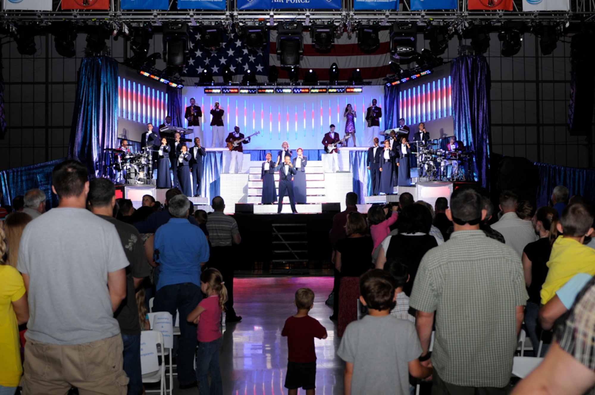 Tops in Blue performers earn a standing ovation at their closing song, "God Bless the USA" during a performance Aug. 2 at RAF Mildenhall, England. The performers tour the world for nine months, sharing their talent with members of the Air Force community. (U.S. Air Force photo by Senior Master Sgt. Thomas Wood)