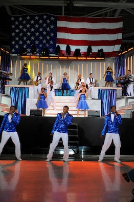 Tops in Blue performers dazzle the audience with high energy Aug. 2 at RAF Mildenhall, England. Tops in Blue is the Air Force's premier entertainment group and tours the world building morale and entertaining Airmen and their families. (U.S. Air Force photo by Senior Master Sgt. Thomas Wood)