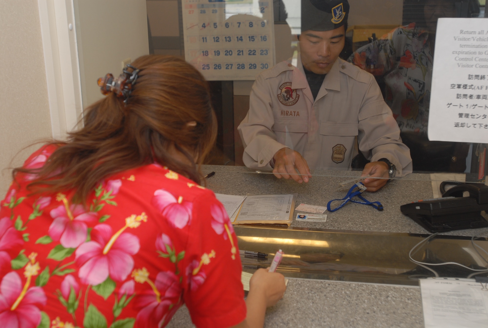 Shitetsu Hirata, 18th Security Forces Squadron, fills out the paperwork required to allow a local Okinawan woman to visit Kadena Wednesday at the Gate 2 Visitor Control Center.  (U.S. Air Force photo/Staff Sgt. Christopher Marasky)