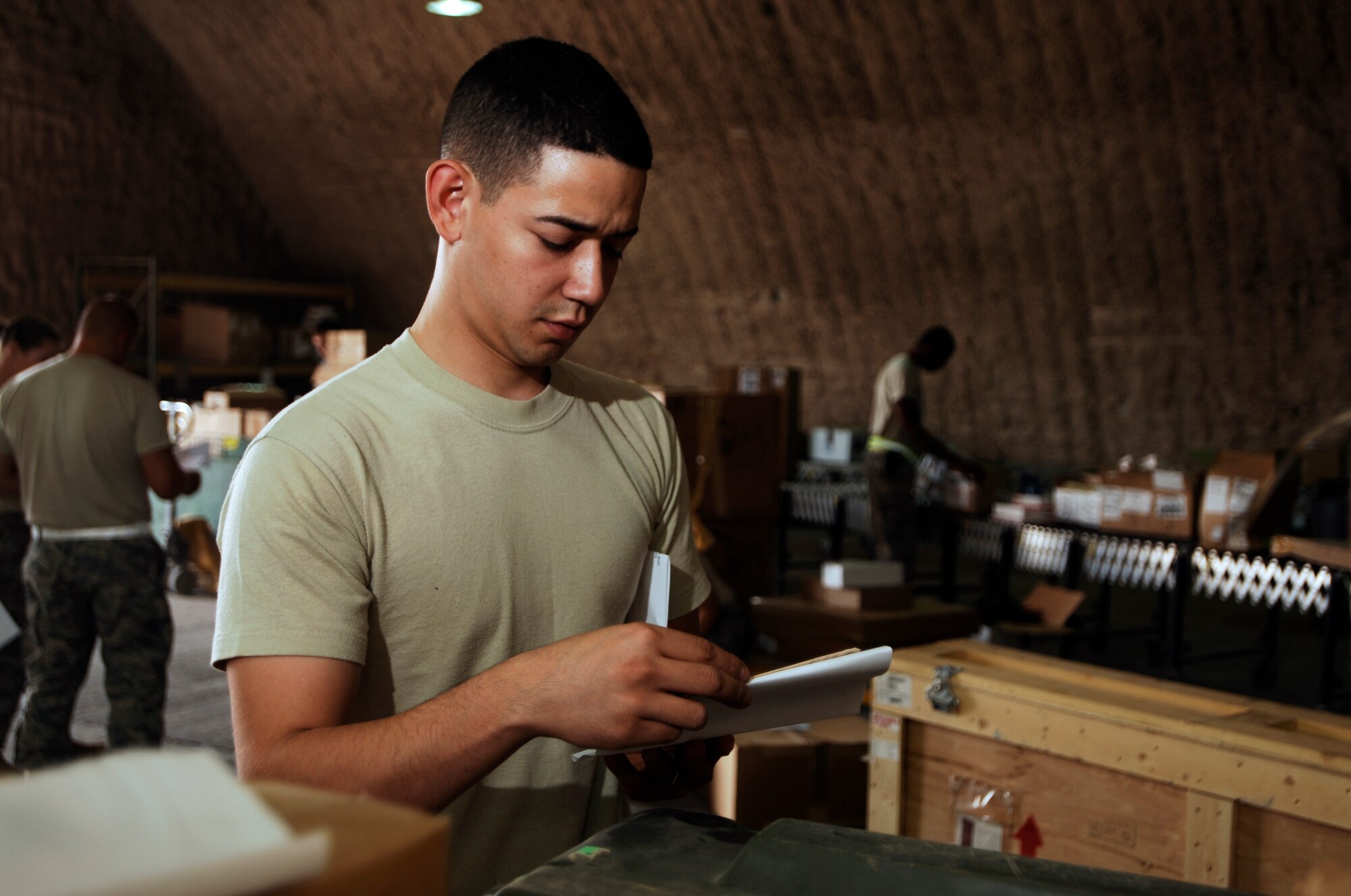 JOINT BASE BALAD, Iraq -- Airman 1st Class Carlos Fuentes validates documentation on parts due in for maintenance here Aug. 5. The 332nd Expeditionary Logistics Readiness Squadron's Receiving Flight Service Center processes approximately 350 aircraft parts a week, including broken parts and replacements. Airman Fuentes, a flight service center journeyman assigned to the 332nd ELRS, is deployed from Davis-Monthan Air Force Base, Ariz. His hometown is Houston. (U.S. Air Force photo/Airman 1st Class Jason Epley)