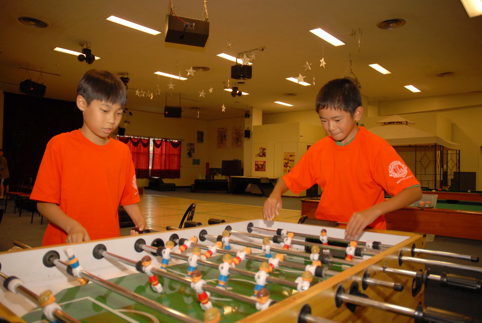 Ren Ishimoto (left) and Kenwa Maeshiro play foosball at the Kadena youth center during an international lock-in August 2. The children spent the night playing games, sampling American and Japanese cuisine and making new friends. (U.S. Air Force photo/Staff Sgt. Angelique Perez)
