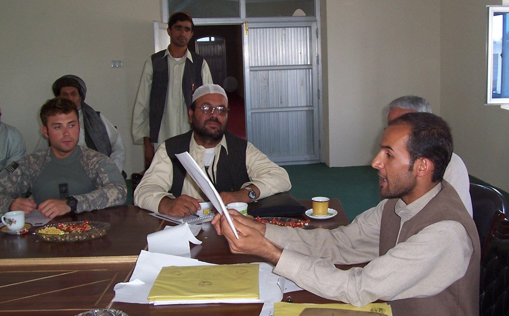 QALAT, Afghanistan -- Members of the Project Coordination Office discuss five bids presented for building a boys’ dormitory in Qalat, Zabul province here Aug 4. The PCO was created to provide transparency for all reconstruction and development efforts within the province. (Photo by Army Staff Sgt. Frank Hinkle)