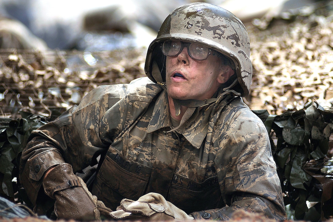 U.S. Air Force Academy basic cadet Jenna Dudley crawls out of a water obstacle on the assault course during training at the U.S. Air Force Academy in Colorado, July 25, 2008. 