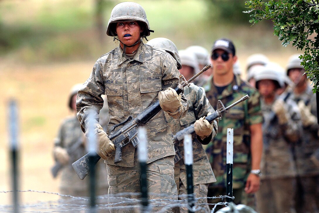 U.S. Air Force Academy basic cadet Stephanie Puzak prepares to attack the low crawl obstacle on the assault course during training at the U.S. Air Force Academy in Colorado, July 25, 2008. 
