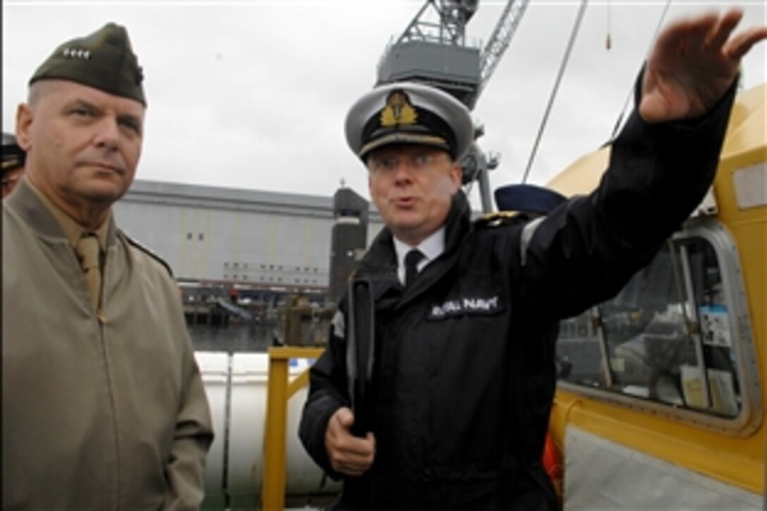 Vice Chairman of the Joint Chiefs of Staff U.S. Marine Gen. James E. Cartwright gets a briefing from Royal Navy Capt. Peter Merriman at HM Naval Base Clyde in Scotland, Aug. 6, 2008. Cartwright viewed Royal Marines conducting an offshore raiding craft demonstration on Clyde River. 