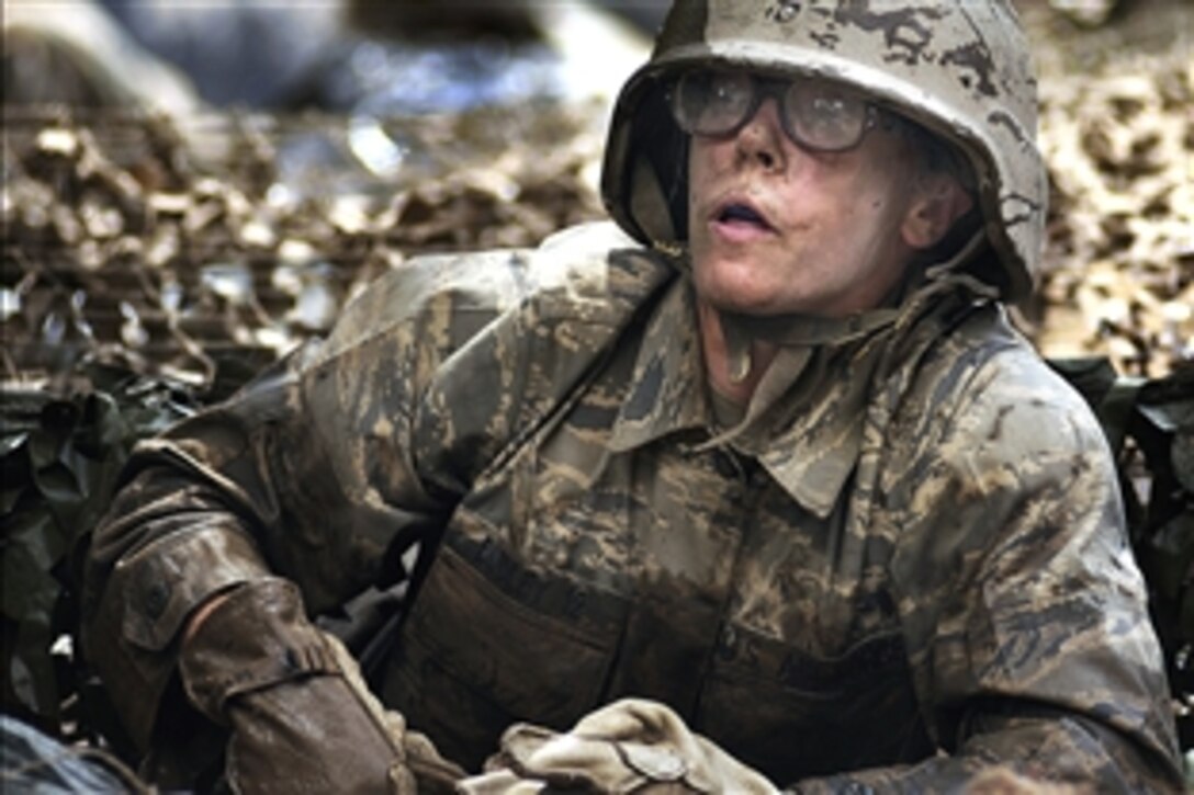 U.S. Air Force Academy Cadet Jenna Dudley crawls out of a water obstacle on the assault course during basic training at the U.S. Air Force Academy in Colorado, July 25, 2008. 