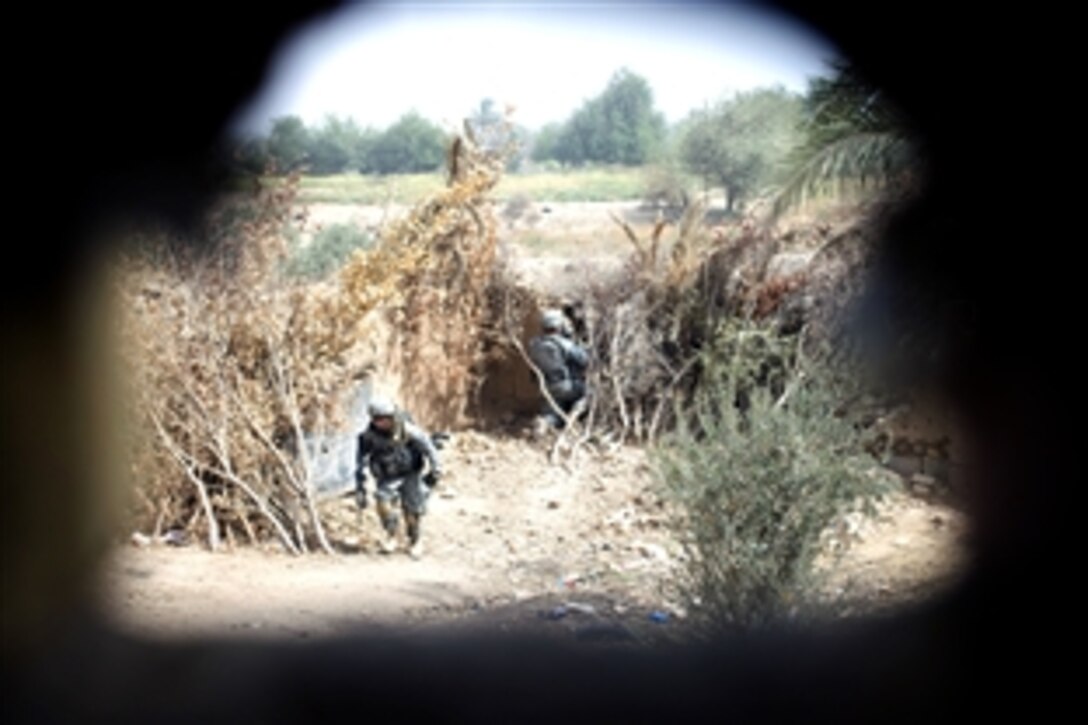 U.S. Army soldiers pinpoint the location of a sniper outside the village of Khan Bani Sad in the Diyala province, Iraq Aug. 5, 2008. The soldiers, assigned to 4th Squadron, 2nd Stryker Calvary Regiment, responded to reports of sniper attacks on the villagers. 
