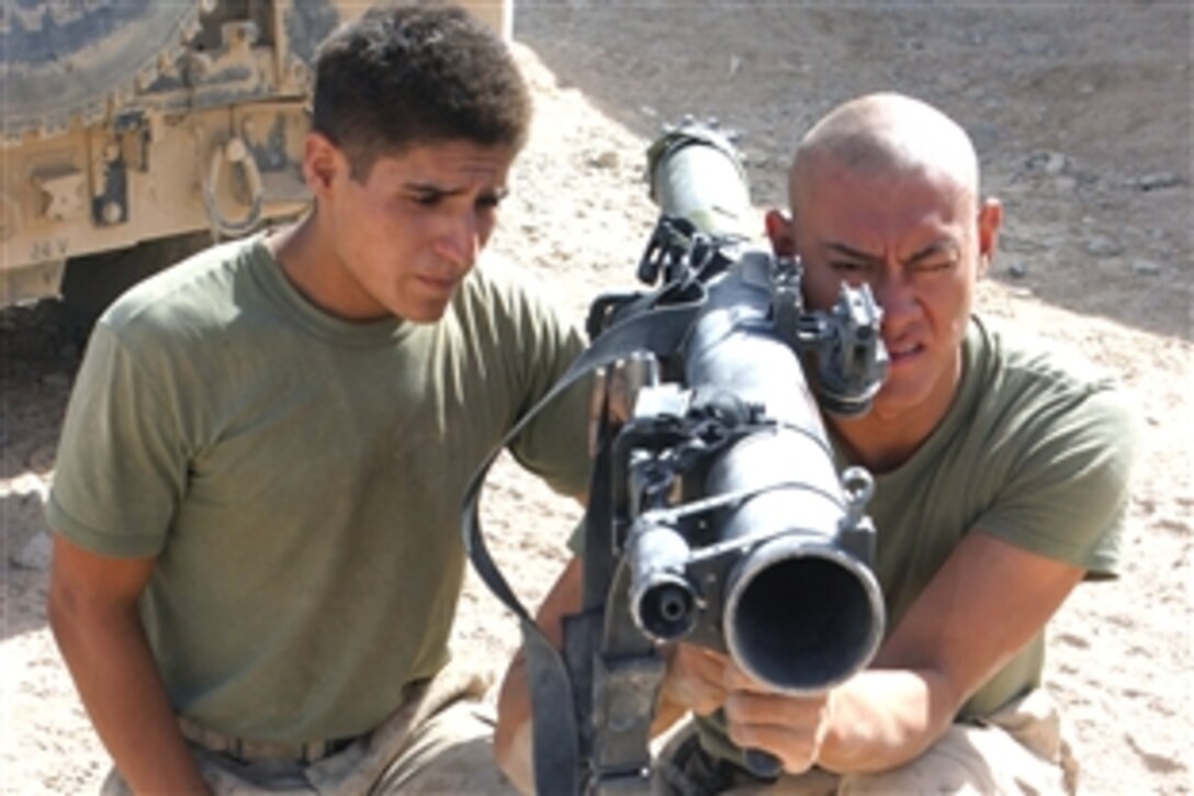 U.S. Marine Lance Cpl. James S. Sproule, left, and Pfc. Sean M. Pettit, right, rehearse fire drills with a practice shoulder-launched multipurpose assault weapon in Now Zad, Afghanistan, July 30, 2008. The Marines are assigned to the 2nd Battalion, 7th Marine Regiment from Marine Air Ground Combat Center, Twentynine Palms, Calif. 