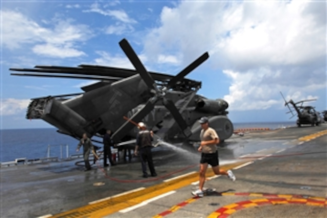U.S. Navy sailors wash their aircraft on the flight deck of the amphibious assault ship USS Tarawa as the ship sails towards the Panama Canal Zone to participate in the multinational training exercise Fuerzas Alidas PANAMAX 2008, Aug. 5, 2008. 