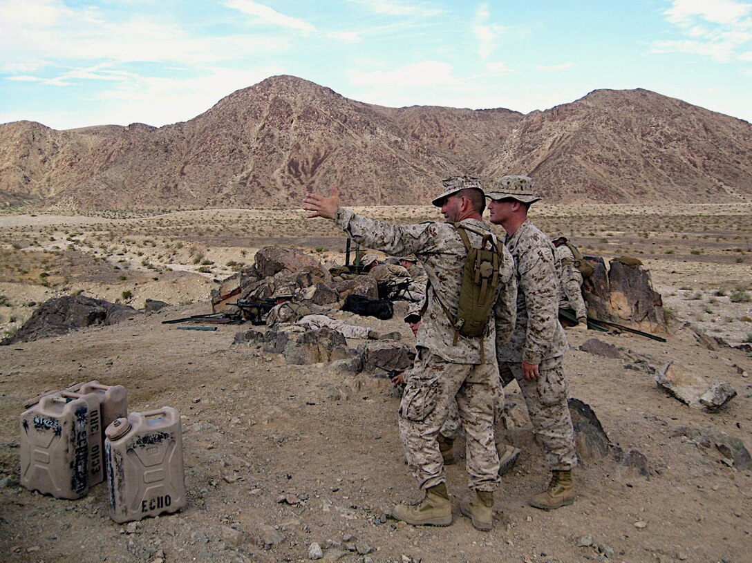 As the range safety officer, Gunnery Sgt. Rodger Hoke (left) explains the designated field of fire for the M249 Squad Automatic Rifle at Range 400 prior to a live-fire exercise for Echo Company, 2nd Battalion, 25th Marine Regiment at Marine Corps Air Ground Combat Center in Twentynine Palms, Calif. Aug. 7, 2008.  The company is scheduled to deploy to Iraq in the fall.