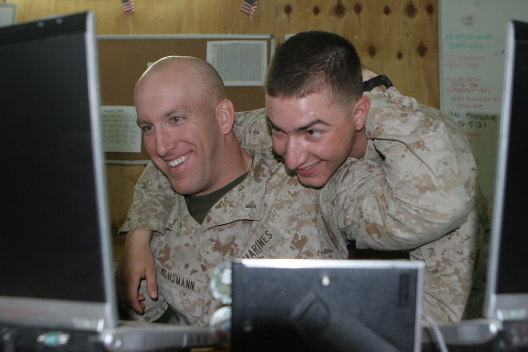 RAMADI, Iraq (August 07, 2008) – Lance Cpl. Michael I. McDonald, a command operations center duty watch clerk with Combat Logistics Company 111, Combat Logistics Battalion 1, 1st Marine Logistics Group, and 1st Lt. Jared P. Klusmann, an operations officer with CLC-111, wrestle with each other while watching a computer monitor at Camp Ramadi, Aug. 7. “I love McDonald’s morale boosting effect on others,” Klusmann said. “He is always motivating Marines around him, whether it’s physical fitness or working.”