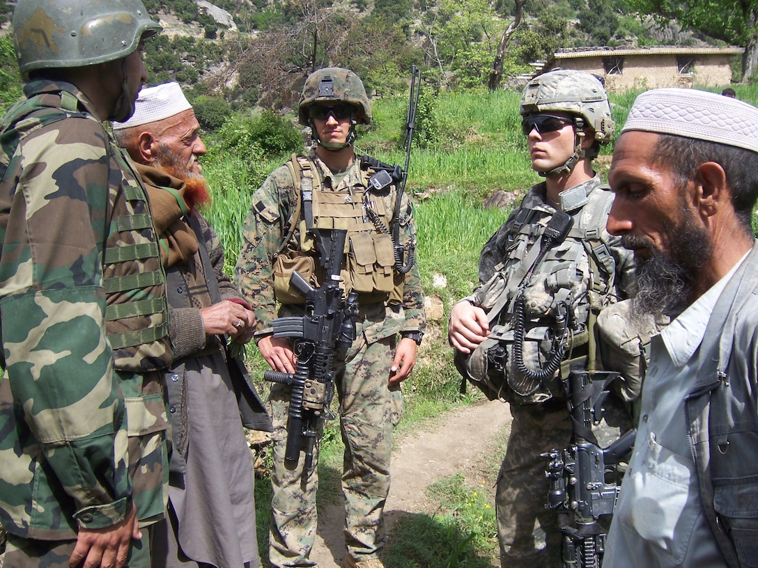 Wire speaks to locals and members of his team during a humanitarian mission in Kandalay, Afghanistan in 2008.