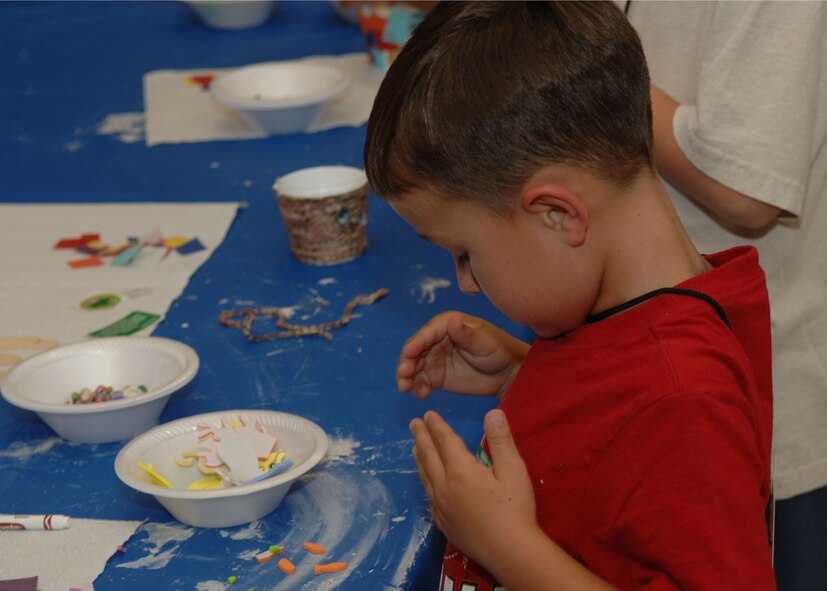 DYESS AIR FORCE BASE, Texas -- Jaxon Travis, son of Michael and Brandy Travis, works on a project during the arts and craft portion of the Vacation Bible School located at the Base Chapel here Aug. 6. Vacation Bible School is a fun time were children can get together and learn about Jesus and the Bible while enjoying snacks, arts and crafts, games and worship. Dyess strives to provide, mental, physical, and spiritual programs to promote total mind and body health. (U.S. Air Force photo/Airman 1st Class Micheal Breaux).