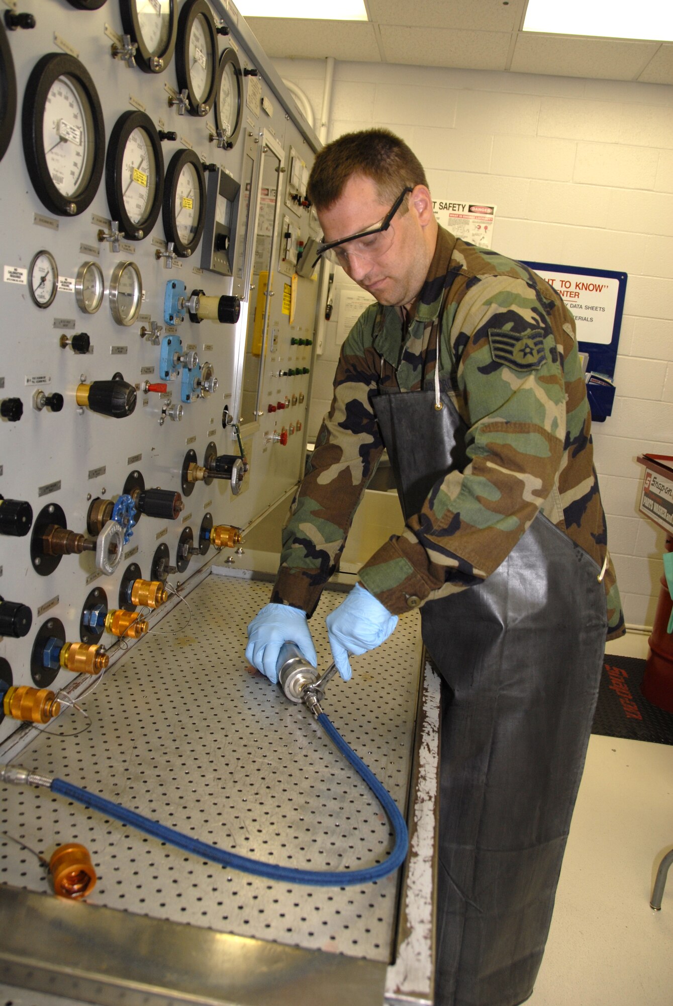 Staff Sgt. Marshall Huisman, a hydraulics technician in the 442nd Maintenance Squadron, adjusts a fitting prior to testing the pressure tolerance on a piece of hydraulic equipment July 12.  The squadron is part of the 442nd Fighter Wing, an Air Force Reserve unit at Whiteman Air Force Base, Mo. (U.S. Air Force photo/Staff Sgt. Tom Talbert)