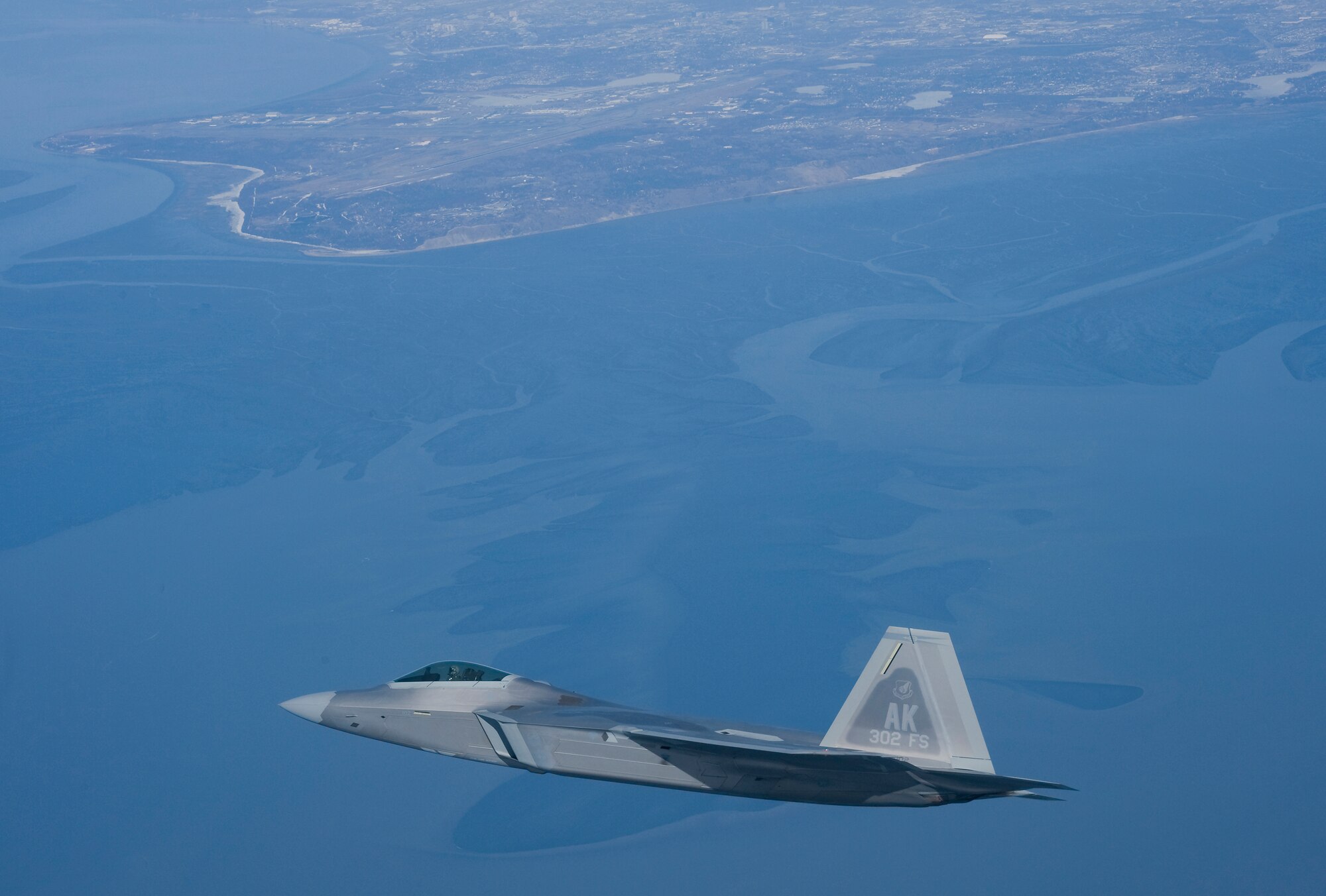 An F-22 Raptor flies above the Anchorage skyline during a routine training mission. This F-22 represents Air Force Reserve Command's first F-22 Associate Unit located at Elmendorf Air Force Base, Alaska. The 302nd Fighter Squadron stood up in October 2007 and belongs to the 477th Fighter Group. (U.S. Air Force photo/ Tech. Sgt. Keith Brown)