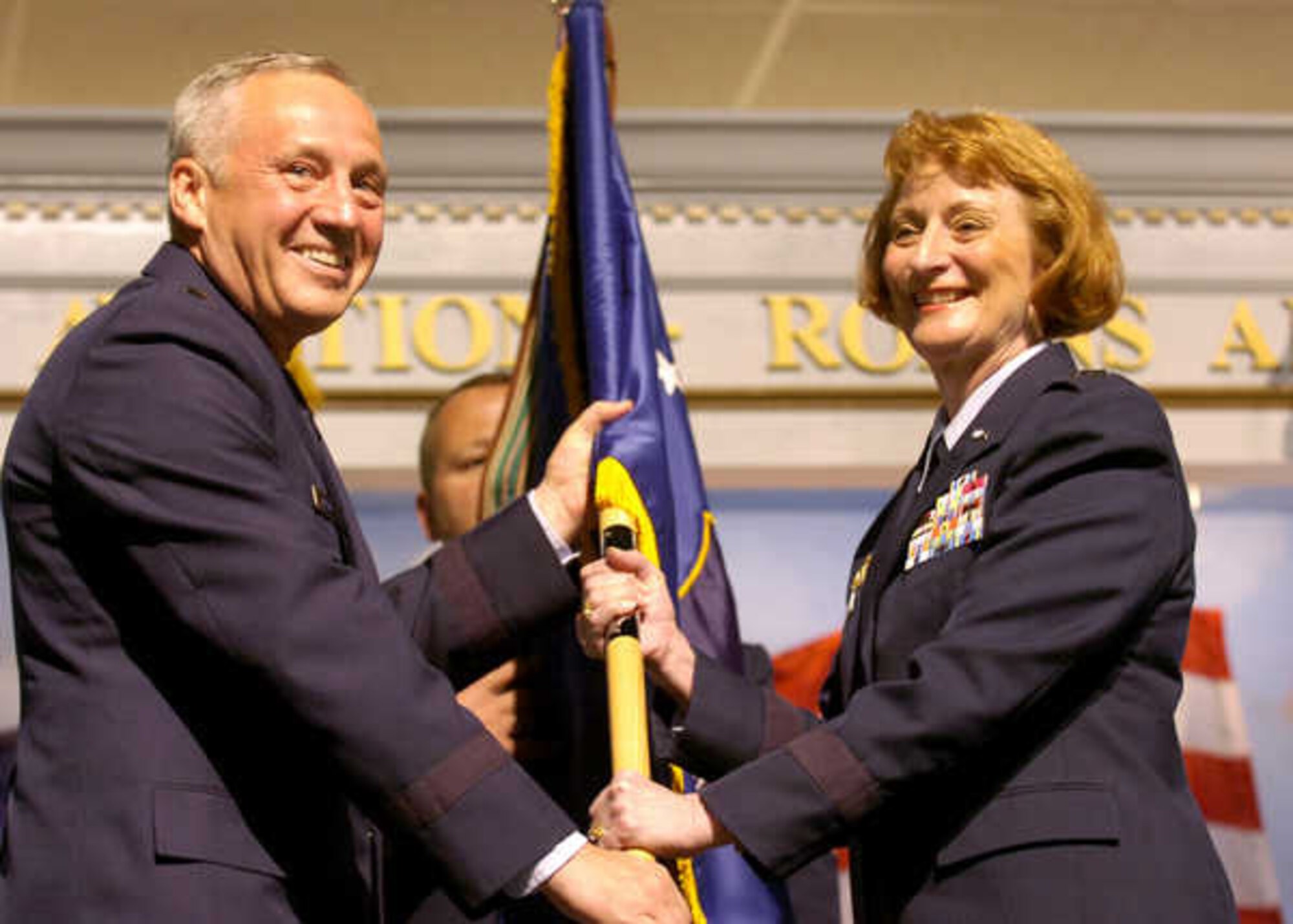 Major Gen. Polly A. Peyer accepts the flag from Gen. Bruce Carlson, commander of Air Force Materiel Command, during the change of command ceremony Aug. 7. (Courtesy photo)