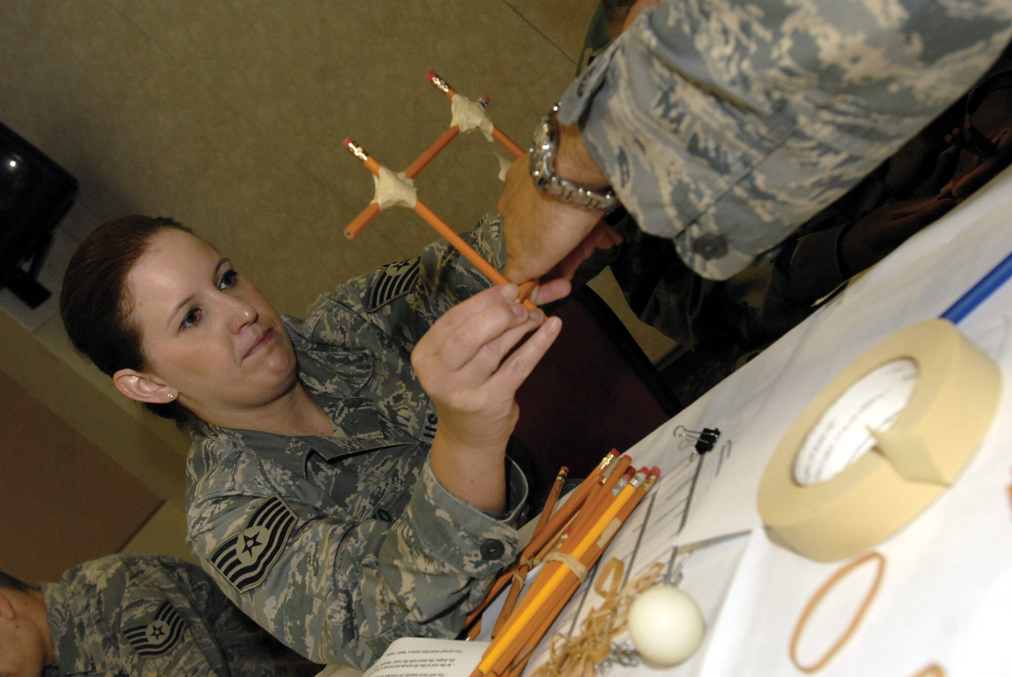 Technical Sergeant Margaret Bisko, 17th Communications Squadron, builds the frame for a catapult during the "Junkyard Wars" team-building exercise at the Senior NCO Orientation Course August 5. (U.S. Air Force photo by Master Sgt. Randy Mallard)
