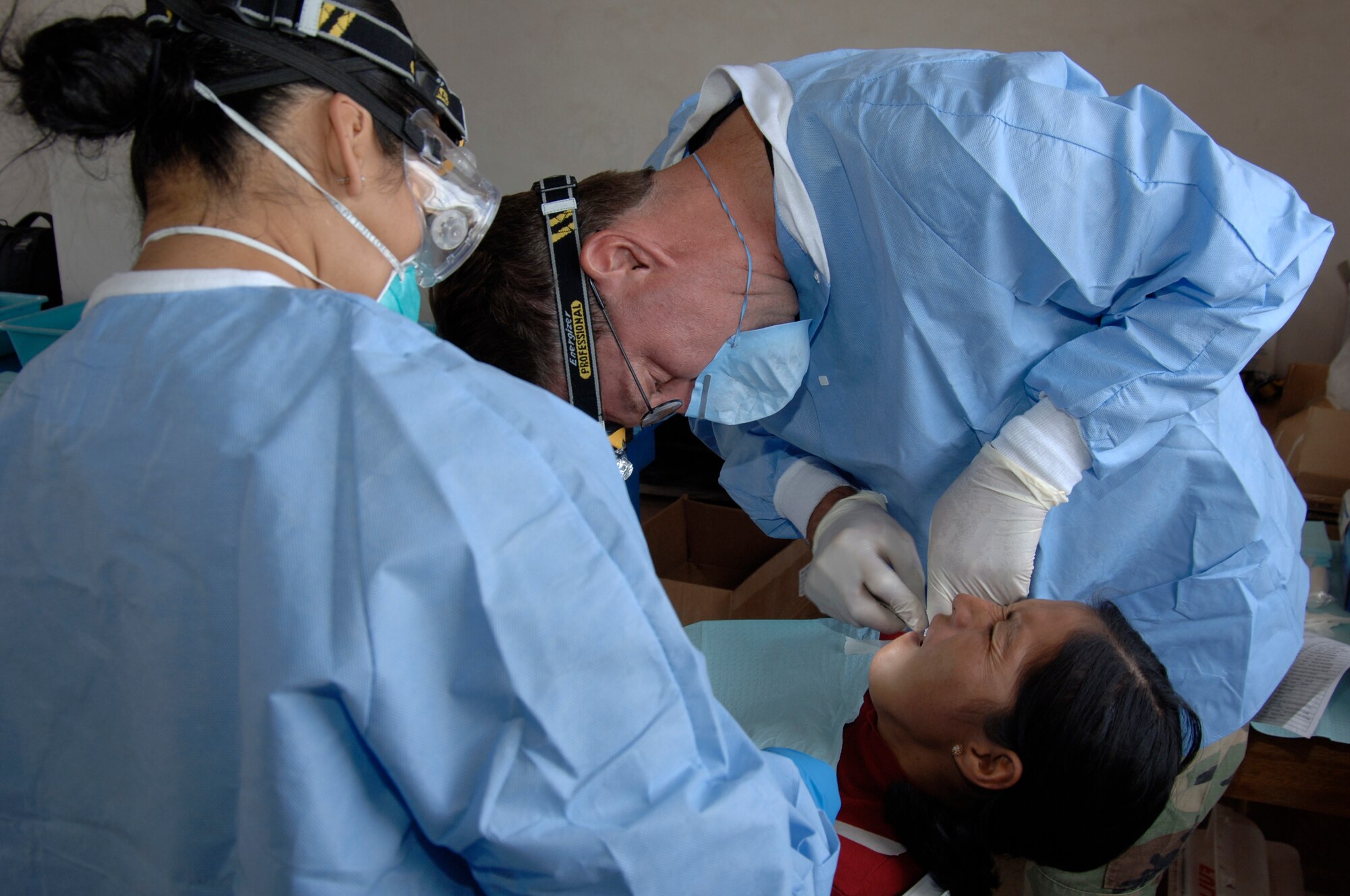 Dr. (Lt. Col.) Walter Weaver, back, and Senior Airman Betty Goldsmith, a dental technician, extract a tooth from a Peruvian woman during a medical mission in Mollepata, Peru, Aug. 1.  A team of 19 medical professionals from the 433rd Medical Group at Lackland AFB, Texas, are deployed to Ayacucho, Peru to support New Horizons - Peru 2008, a humanitarian mission set on bringing quality-of-life construction projects and a total of nine medical missions to underpriviliged Peruvians. (U.S. Air Force photo/1st Lt. Mary Pekas)