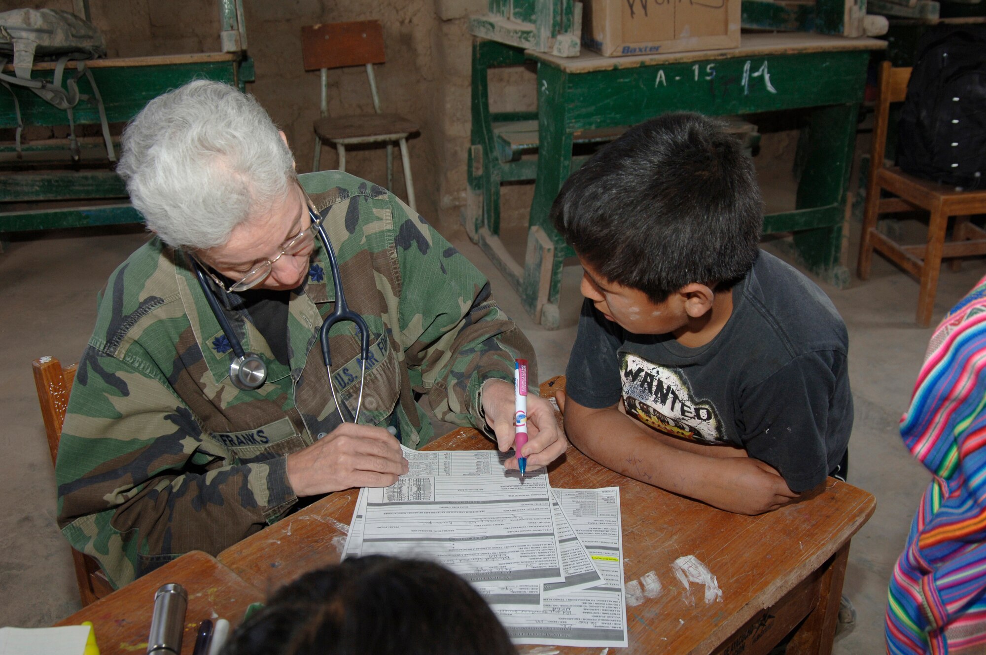 Dr. (Lt. Col.) Dain Franks, a doctor from the 433rd Medical Group at Lackland AFB, Texas, performs a medical assesment on a Peruvian boy, Aug. 1, during a medical readiness training exercise in Mollepata, Peru.  The exercise is one of nine supporting New Horizons - Peru 2008, a U.S. and Peruvian effort to provide humanitarian aid to the people of Ayacucho, Peru. (U.S. Air Force photo/1st Lt. Mary Pekas)
