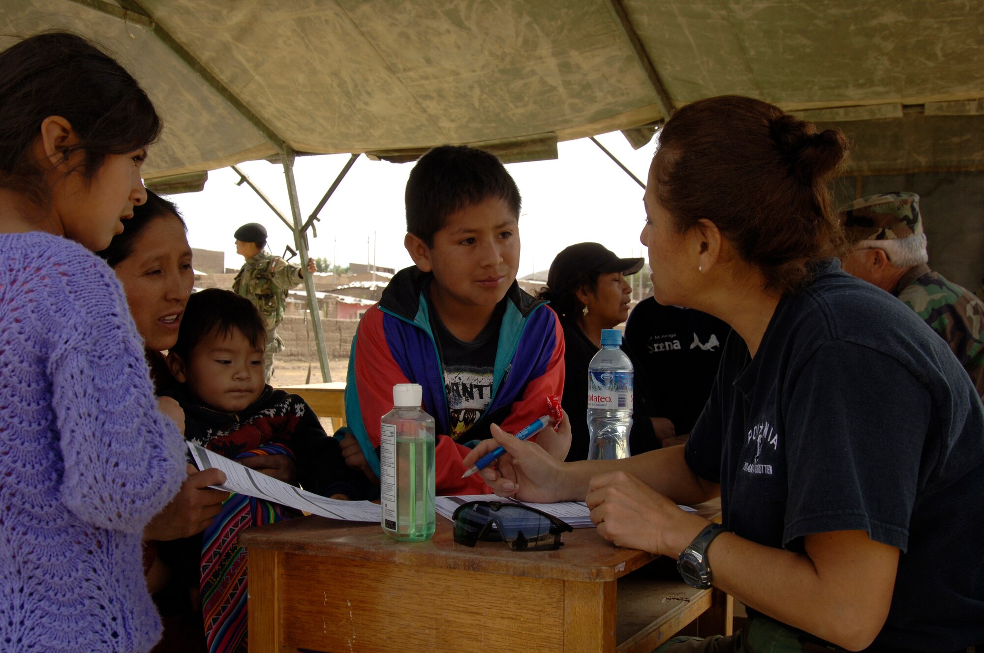 Lt. Col. Diana Flores, an international health specialist from the 433rd Medical Group at Lackland AFB, Texas, performs triage on a Peruvian family, Aug. 1, during a medical mission in Mollepata, Peru.  A team of 19 medical professionals deployed to Ayacucho, Peru supporting the final three of nine medical missions as part of New Horizons - Peru 2008, a humanitarian effort to bring quality-of-life projects to Ayacucho, Peru. (U.S. Air Force photo/1st Lt. Mary Pekas)