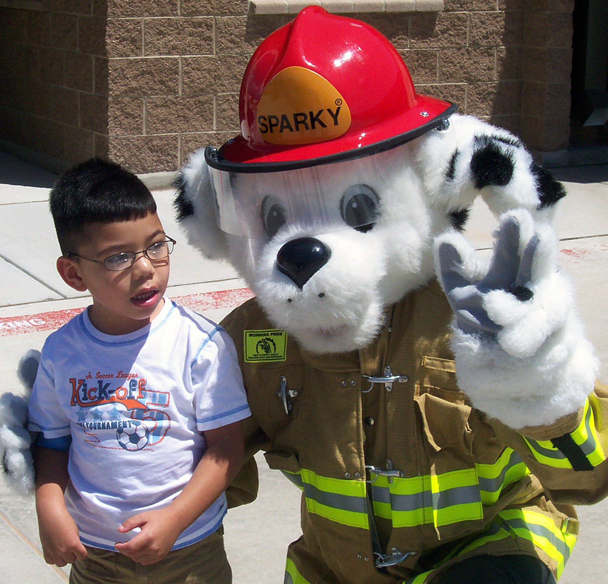 Joshua Daniel Aragon and his parents Crystal and Lyman Woodward, visited Kirtland Air Force Base, New Mexico, July 29, for a special tour and ride. Joshua has cerebral palsy and epilepsy and the Fire Department decided to give him a visit from Sparky, the mascot for fire fighters everywhere, and a tour of the facilities. U.S. Air Force photo by EAnnette Oliver