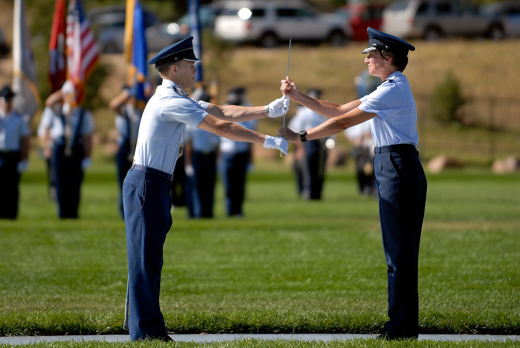 During the cadet change of command ceremony at the U.S. Air Force Academy, Fall commander Cadet 1st Class Jacob Schonig receives the saber from Commandant of Cadets Brig. Gen. Susan Desjardins Aug 6 on the Stillman Parade Field near Colorado Springs, Colo. (U.S Air Force photo/Mike Kaplan)