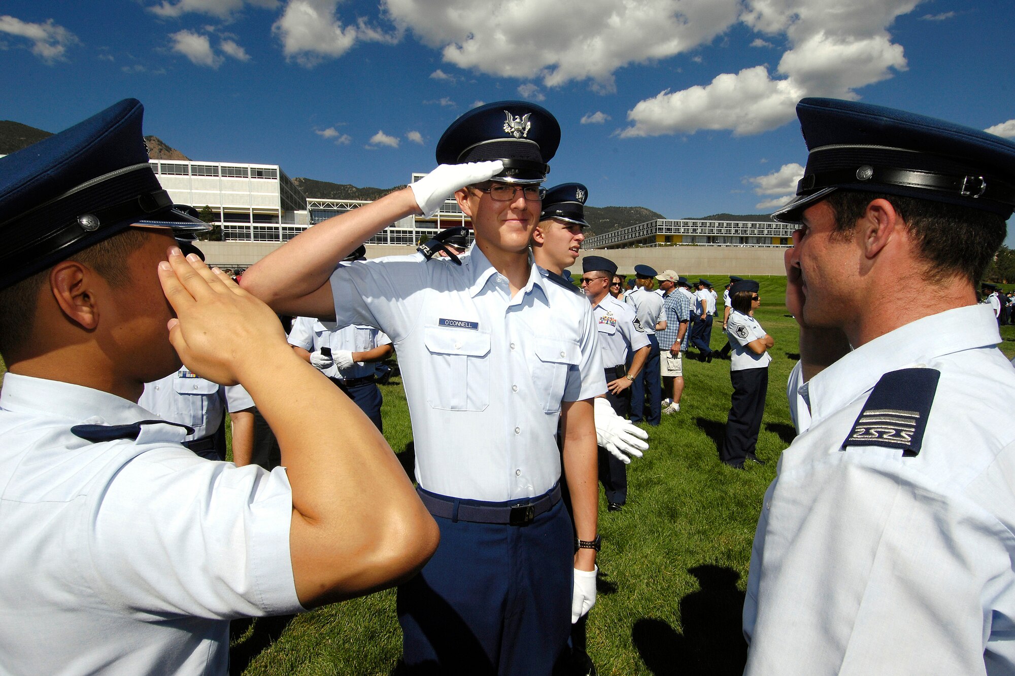 U.S. Air Force Academy Cadet 4th Class Kody O'Connell returns salutes given by Cadet 2nd Class Alexander Paladino and Cadet 1st Class Jason Griggs Aug 6 after they pinned on his shoulder boards on the Stillman Parade Field near Colorado Springs, Colo. (U.S Air Force photo/Mike Kaplan)