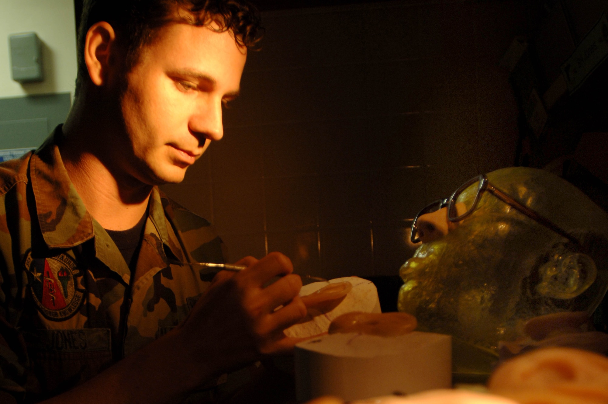 Senior Airman Justin Jones, a maxillofacial prosthetic technician, 59th Dental Squadron, creates a new ear for a patient using a model created by the stereolithography lab at MacKown Dental Clinic. (U.S. Air Force photo/Staff Sgt. Erin Peterson) 