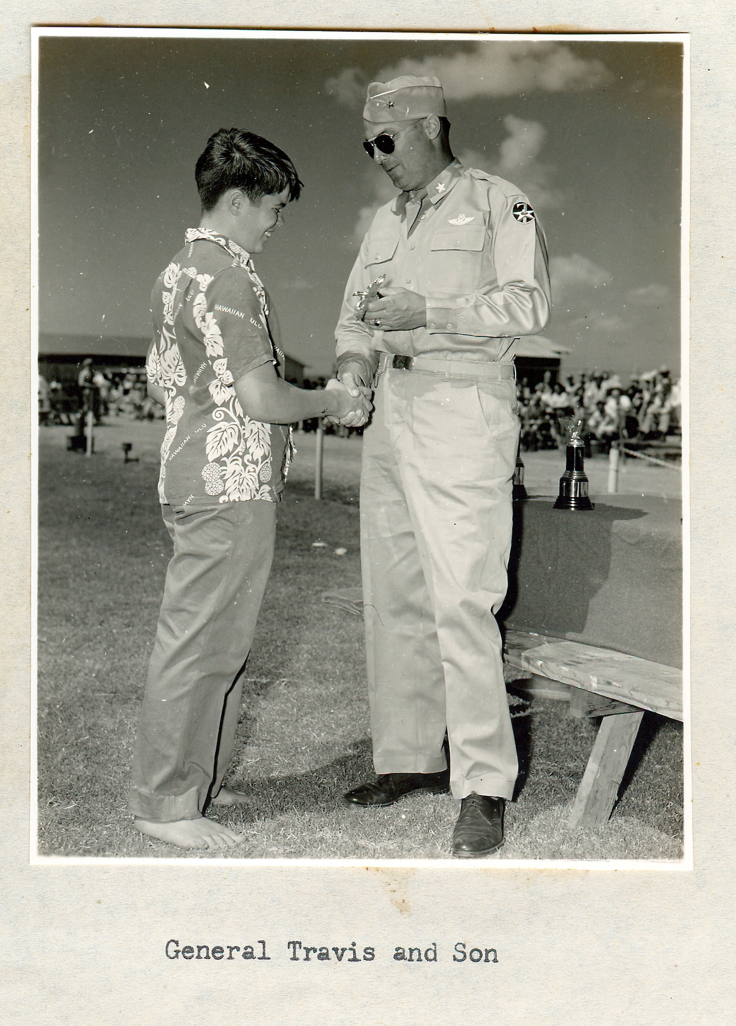 Brig. Gen. Robert Travis gives son Robert Travis ,Jr., a trophy at Hickam Air Force BAse, Hawaii in 1948. (U.S. Air Force photo)