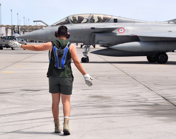 A French air force ground crewmen guides a Rafale fighter to its parking spot upon arrival at Nellis Air Force Base, Nev., on Aug. 7.  The French team is at Nellis for Red Flag 08-4, an two-week exercise that pits forces in a realistic aerial "battlefield" to hone the fighting skills of American and allied airmen.  Republic of Korea, Indian, Navy and Air Force teams are joining the French air force in Red Flag 08-4.  (U.S. Air Force photo by Chief Master Sgt. Gary Emery) 