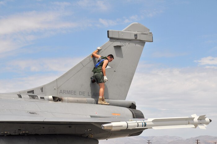 A French air force ground crew member checks the health of a Rafale fighter after its arrival at Nellis Air Force Base, Nev., on Aug. 7 for Red Flag 08-4.  Red Flag is a two-week exercise that pits forces in a realistic aerial "battlefield" to hone the fighting skills of American and allied airmen.  Republic of Korea, Indian, Navy and Air Force teams are joining the French air force in Red Flag 08-4.  (U.S. Air Force photo by Chief Master Sgt. Gary Emery) 