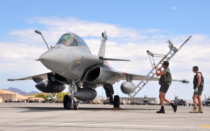 French air force ground crewmen provide a boarding ladder for a Rafale fighter aircrew upon upon their arrival at Nellis Air Force Base, Nev., on Aug. 7.  The French team is at Nellis for Red Flag 08-4, an two-week exercise that pits forces in a realistic aerial "battlefield" to hone the fighting skills of American and allied airmen.  Republic of Korea, Indian, Navy and Air Force teams are joining the French air force in Red Flag 08-4.  (U.S. Air Force photo by Chief Master Sgt. Gary Emery) 