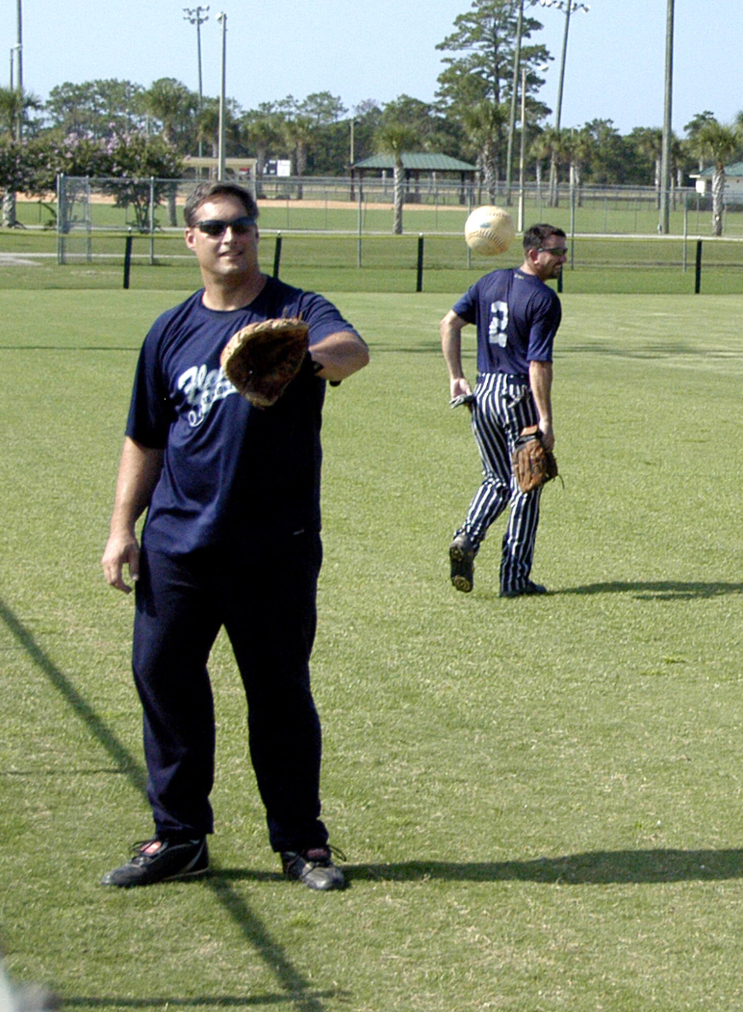 Navy CAPT (Ret.) David Fuhrmann warms up by playing catch will another member of the Florida Air National Guard team at this years 43rd Annual Air National Guard Softball Tournament. (Air Force photo by 1st Lt Jared Scott)                                 