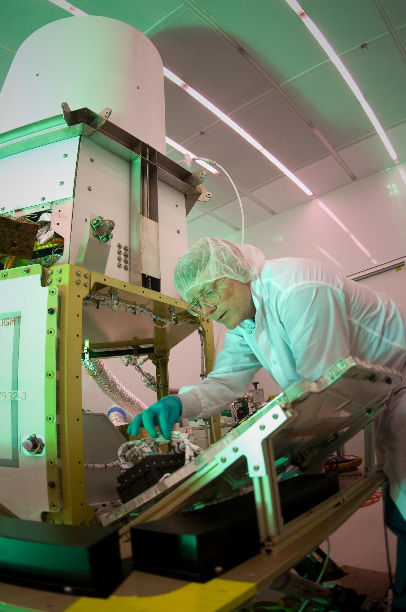 Martin Leahy performs voltage and continuity tests on a tactical satellite, known as Tactical Satellite-3, at the Space Vehicle Directorate at the Air Force Research Laboratory, Kirtland Air Force Base, N.M.  The satellite is scheduled to be launched in October. Mr. Leahy is a field engineer with ATA Aerospace.  (U.S. Air Force photo/Lance Cheung) 