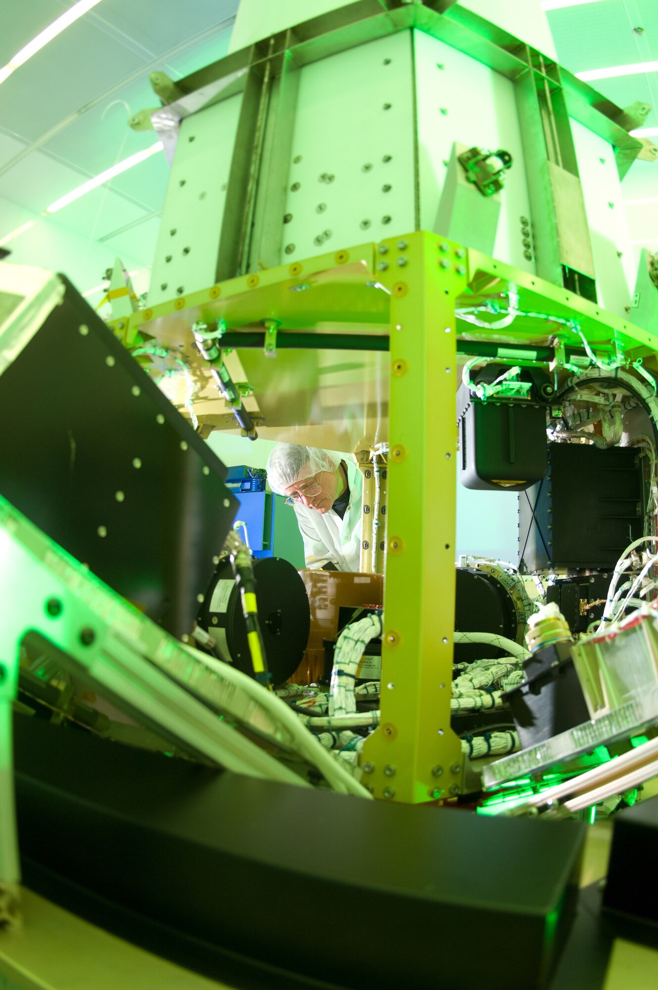 Martin Leahy performs voltage and continuity tests on a tactical satellite, known as Tactical Satellite-3, at the Space Vehicle Directorate at the Air Force Research Laboratory, Kirtland Air Force Base, N.M.  The satellite is scheduled to be launched in October. Mr. Leahy is a field engineer with ATA Aerospace.  (U.S. Air Force photo/Lance Cheung) 