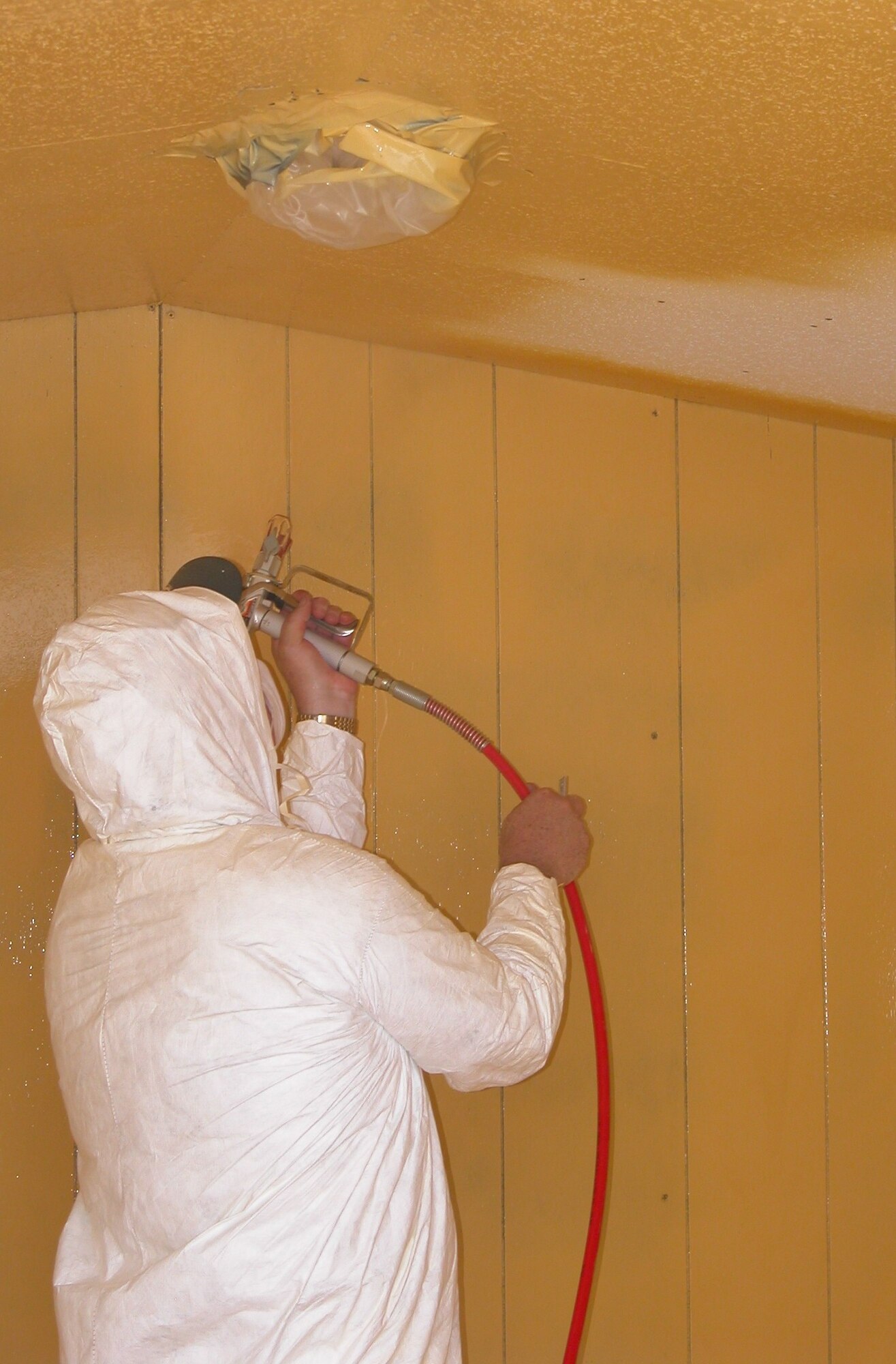 Scott MacLean, a research scientist with Air Force Research Laboratory's Materials and Manufacturing Directorate, applies a barrier coating to a large scale testing facility at Tyndall Air Force Base, Fla. The research evaluated various coatings ability to protect structures from chemical warfare agents. (photo courtesy of Applied Research Associates)
