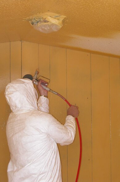 Scott MacLean, a research scientist with Air Force Research Laboratory's Materials and Manufacturing Directorate, applies a barrier coating to a large scale testing facility at Tyndall Air Force Base, Fla. The research evaluated various coatings ability to protect structures from chemical warfare agents. (photo courtesy of Applied Research Associates)