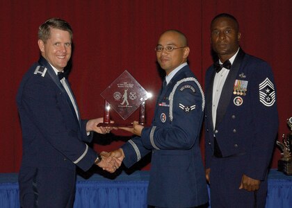 7/30/2008 - Colonel Eric Wilbur, 37th Training Wing vice commander,  and Chief Master Sgt Juan Lewis, 37th Training Wing command chief presents Airman 1st Class Jacinto San Nicolas with the 2007 37th Training Wing Honor Guard Member of the Year award. (USAF photo by Alan Boedeker)                            